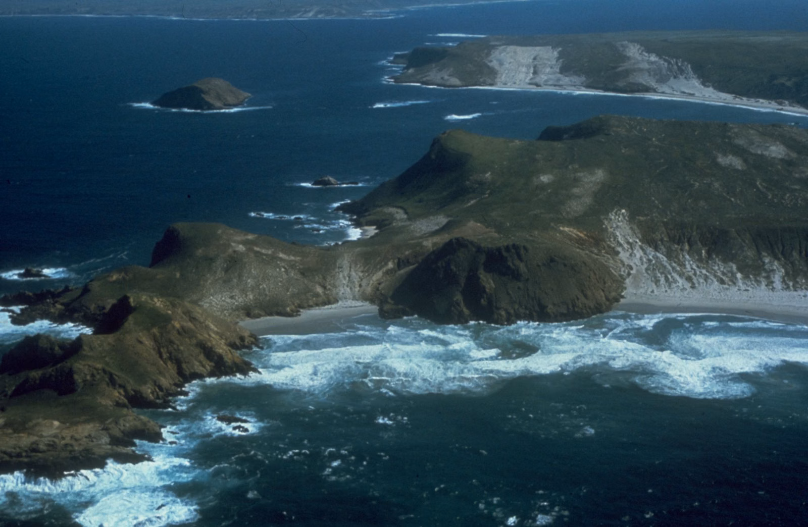 Aerial view of rugged Channel Islands coastline and surf
